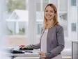 mitarbeiterin-office-sutter-medizintechnik.jpg Mitarbeiterin von Sutter Medizintechnik an einem höhenverstellbaren Schreibtisch – modernes Arbeitsumfeld mit Fokus auf Ergonomie