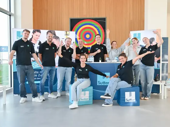 Teamfoto am Informationsstand der Nacht der Ausbildung mit Auszubildenden und Mitarbeitenden.
